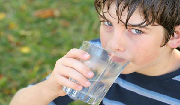 shot of a boy drinking a glass of water